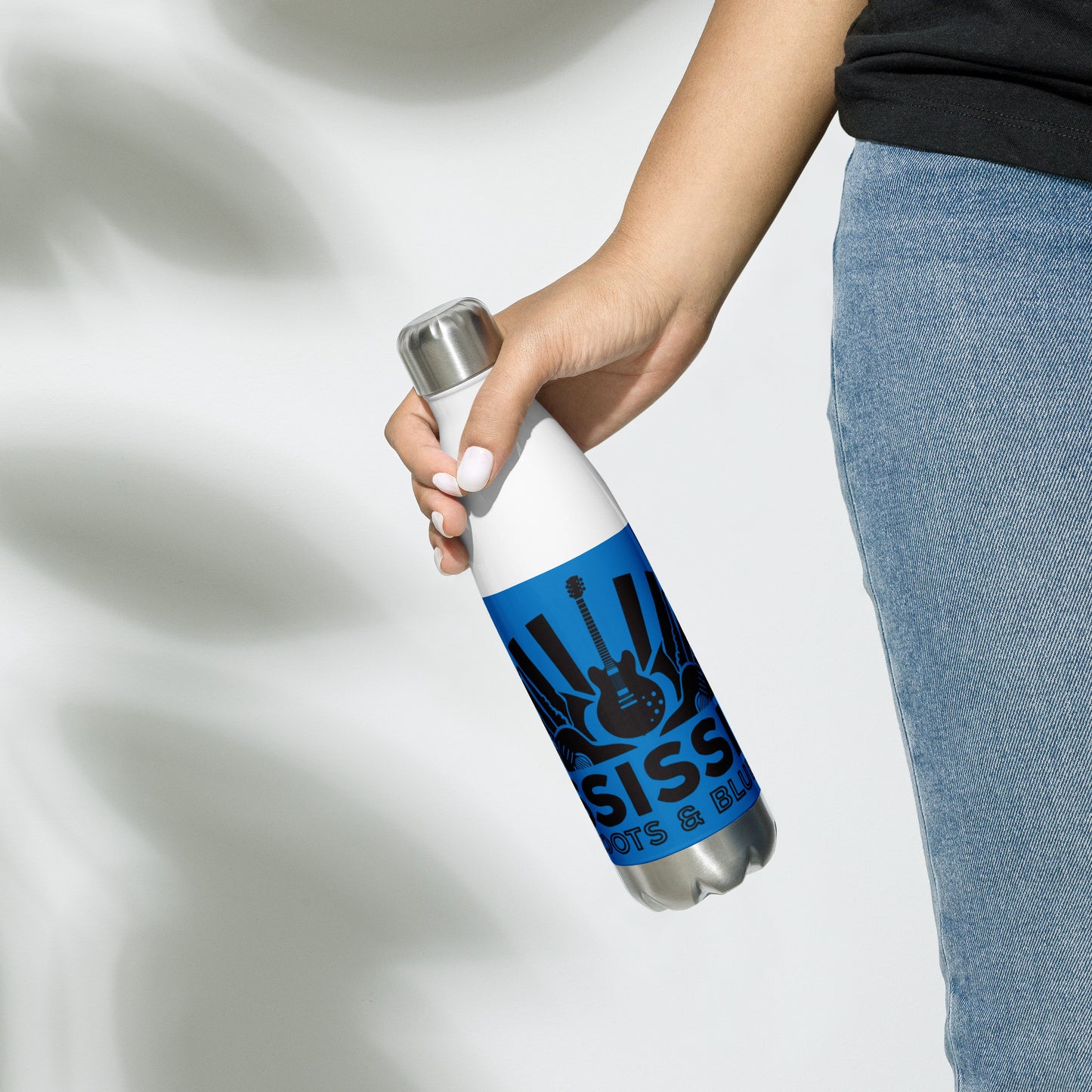 insulated water ball with blues graphics and blue background being held in woman's right hand at her side