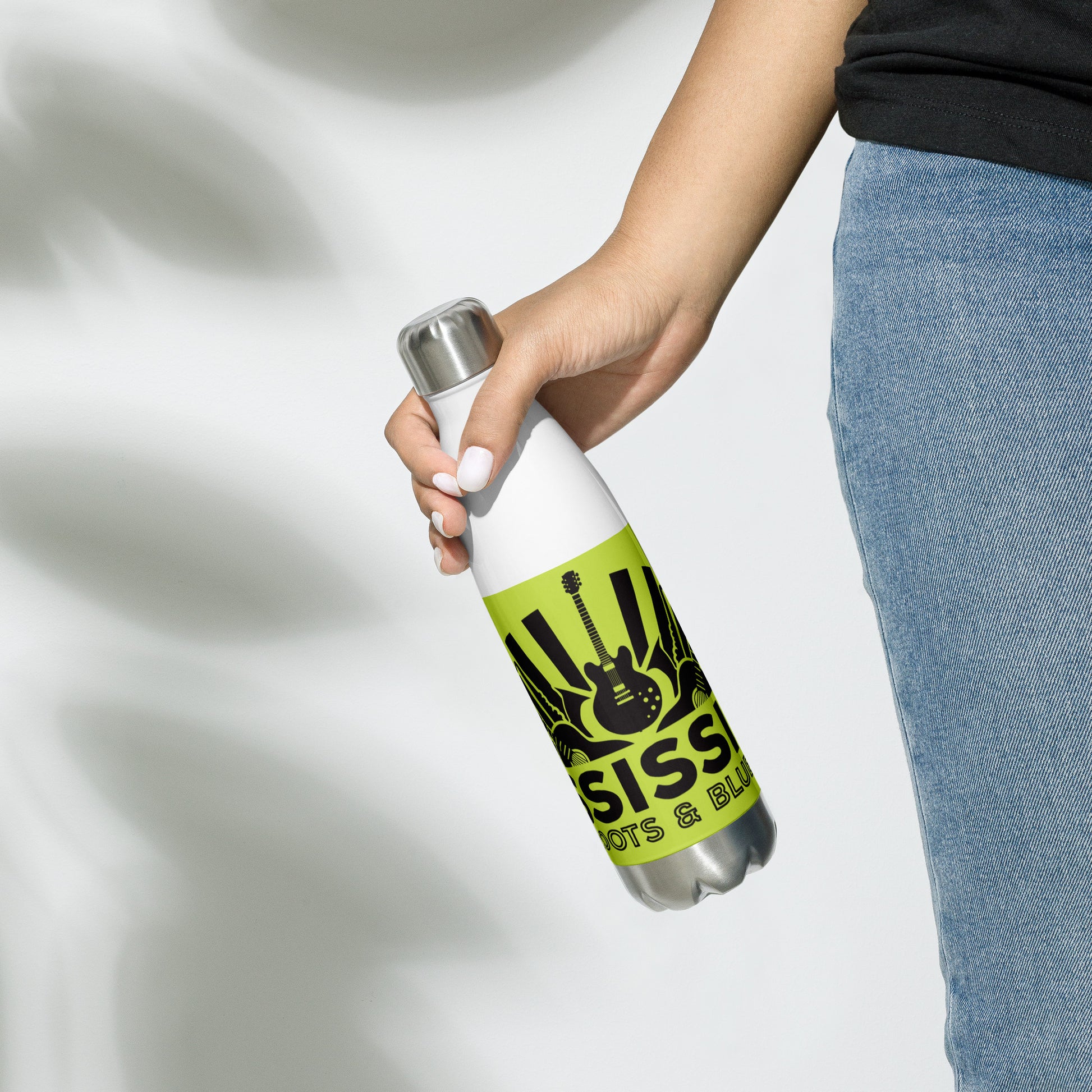 insulated water ball with blues graphics and green background at woman's side in her right hand