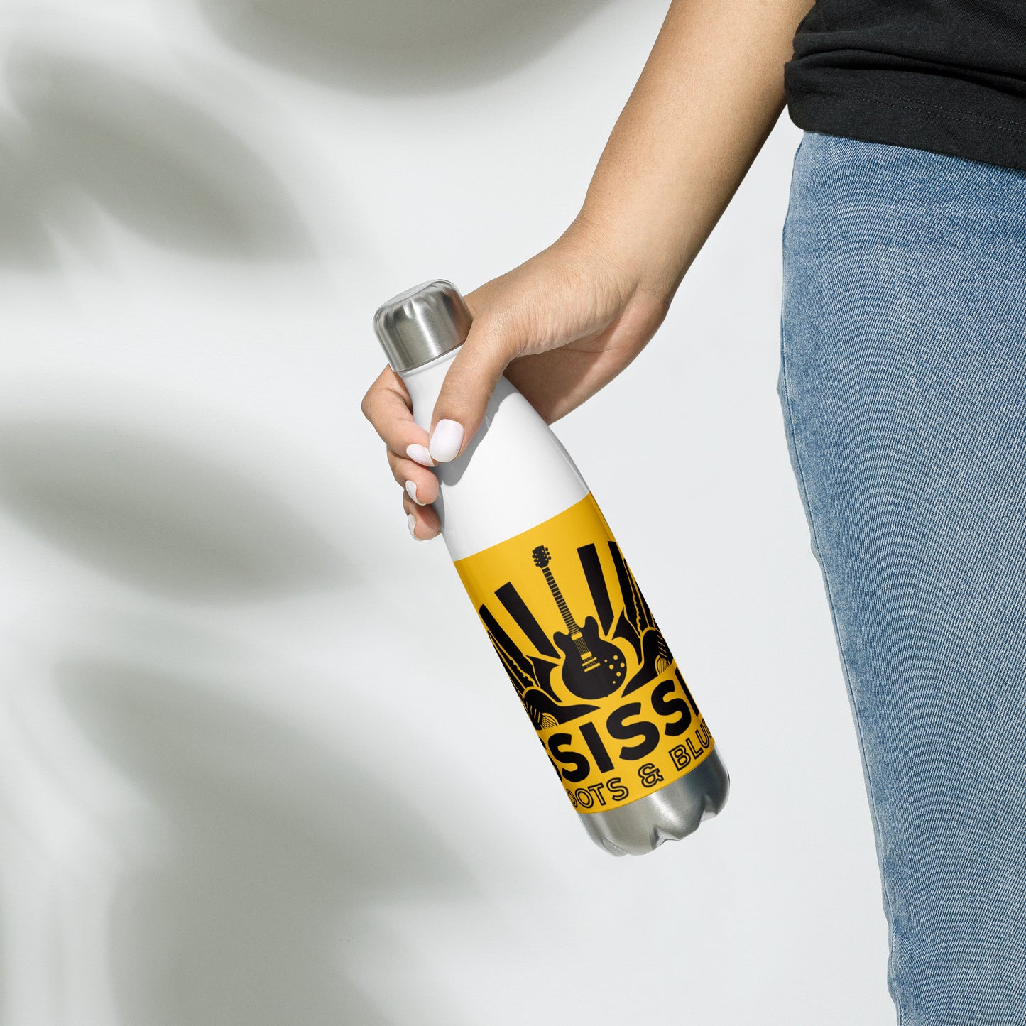 insulated water ball with blues graphics and yellow background being held by woman in right hand at her side