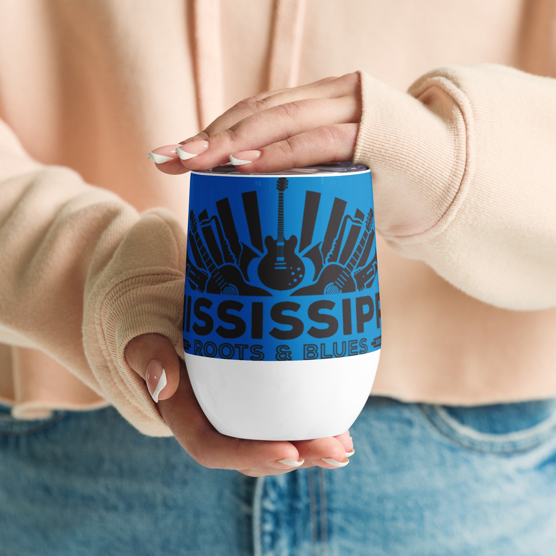 wine cup with blues logo and blue background being displayed in two hands waist high